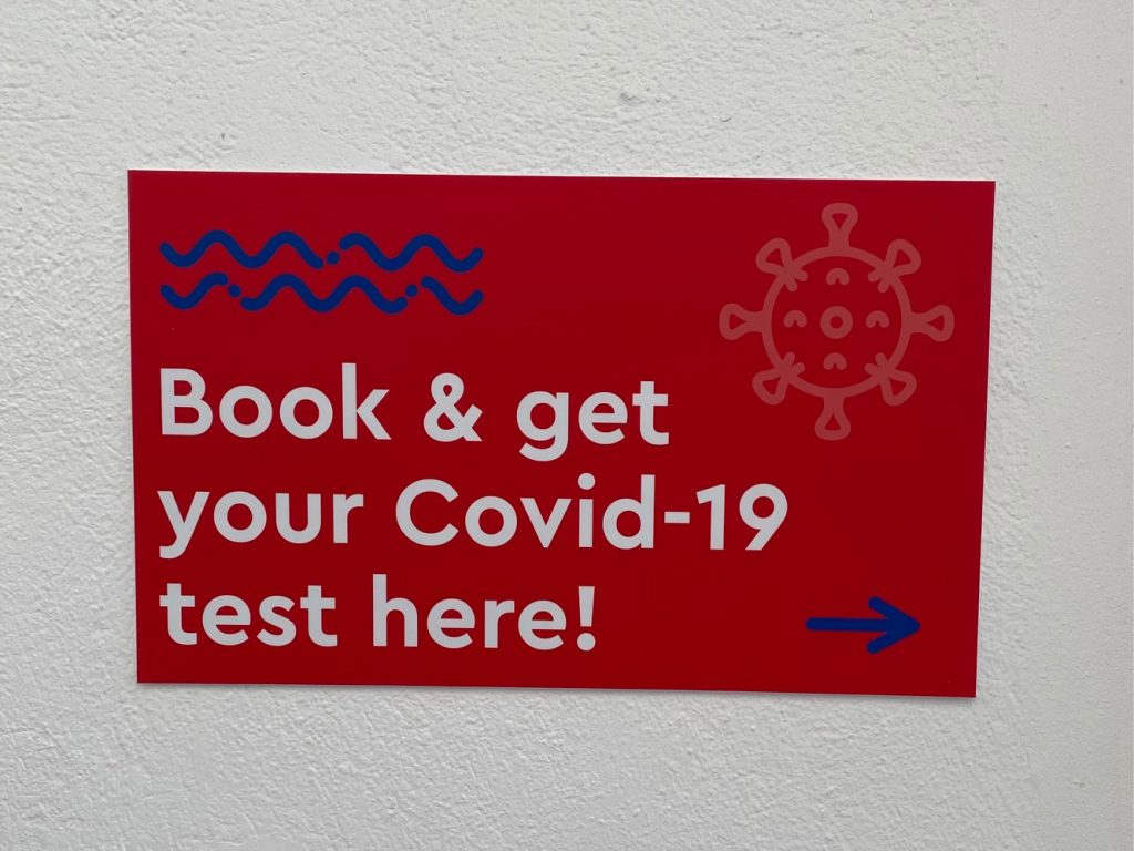 Wall sign offering COVID tests | Where to Get a COVID Test in Greece | greekislandbucketlist.com